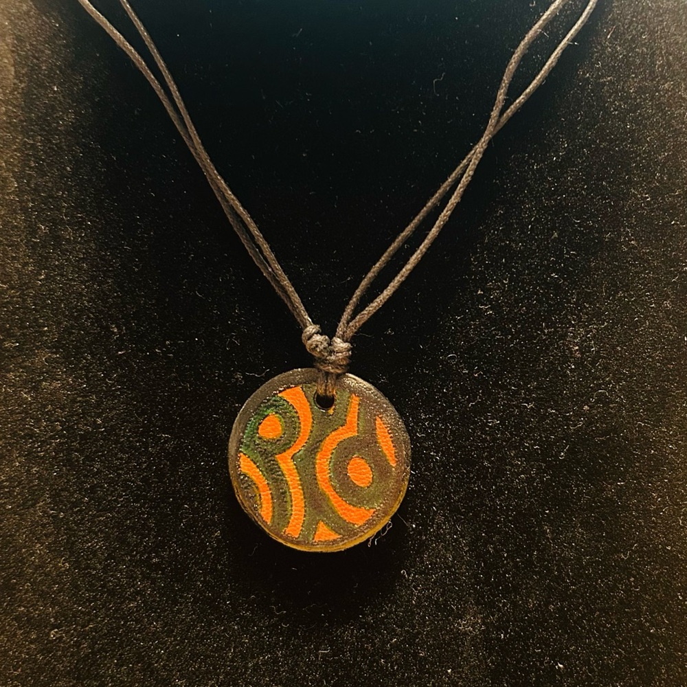 Ten Thousand Villages choker. Orange black green length is short or long + light
